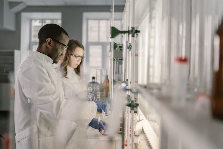 Two scientists conducting research in a modern laboratory setting with focus on chemistry.