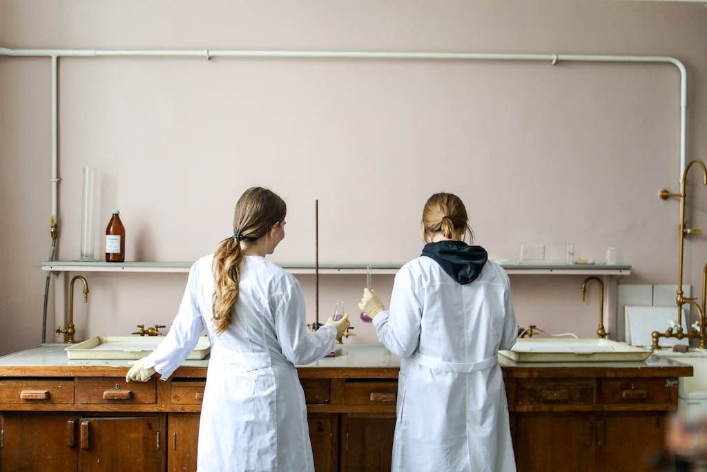 Two female scientists working on an experiment in a laboratory setting.